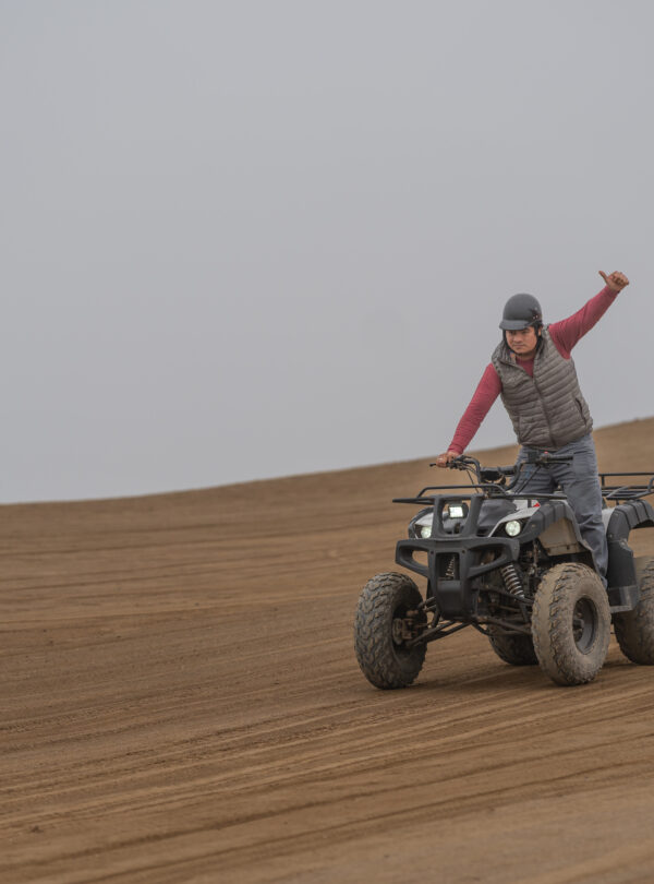 Man gesturing to be okay while driving a quad bike